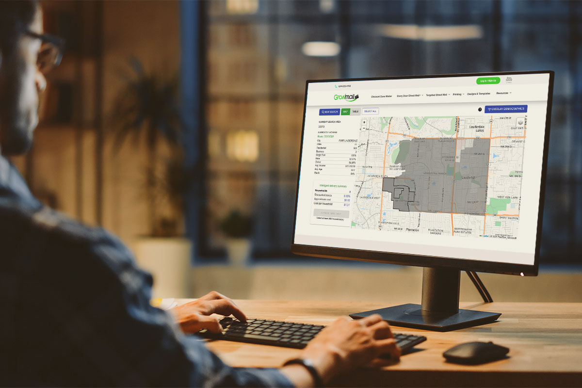 Image of someone on a computer with a Growmail direct mail map on the screen